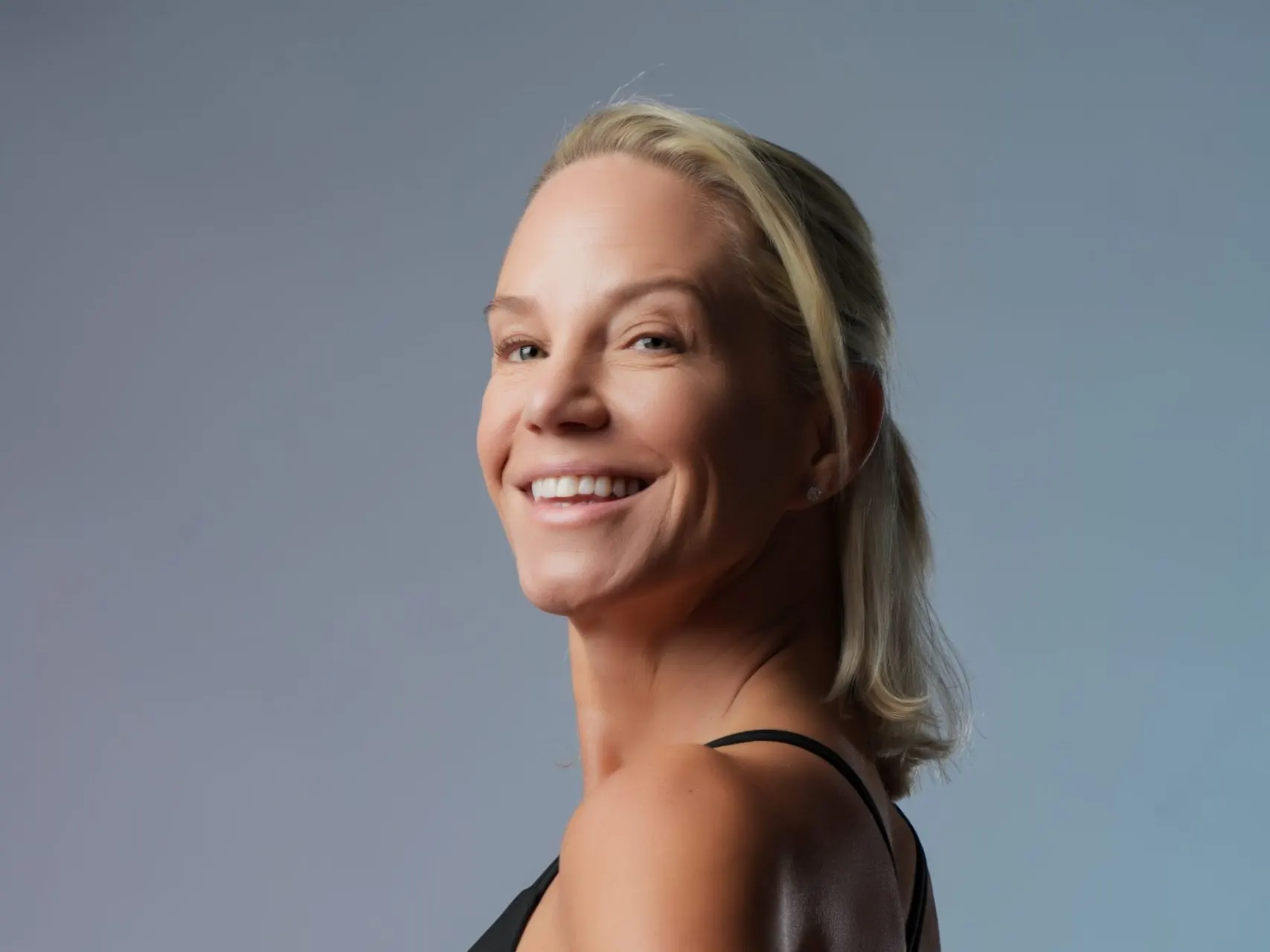 Coach Karina Joyce smiling in a black athletic top